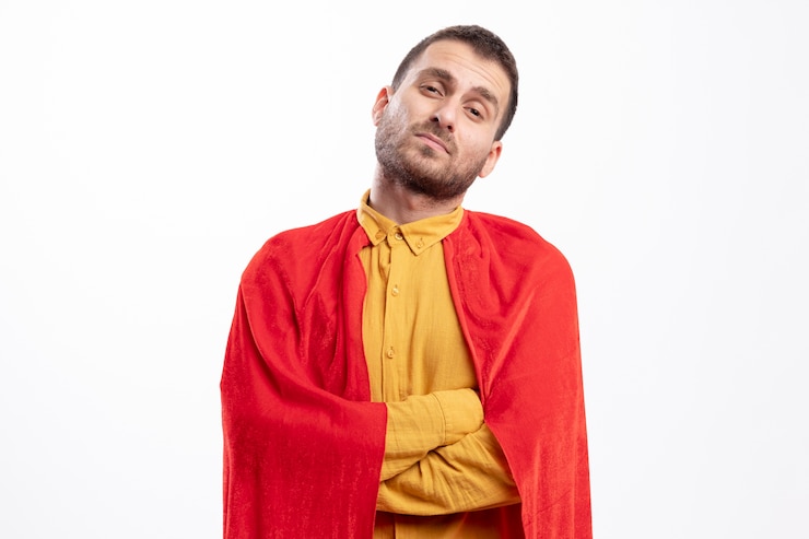 Free Photo confident caucasian superhero man with red cloak stands with crossed arms isolated on white wall with copy space