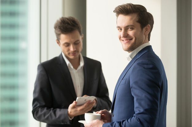 Confident CEO drinking coffee and planning work day