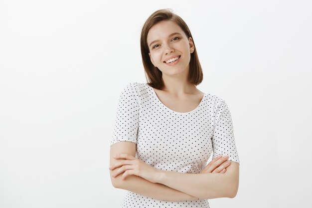 Confident cheerful female student cross arms chest and looking happy