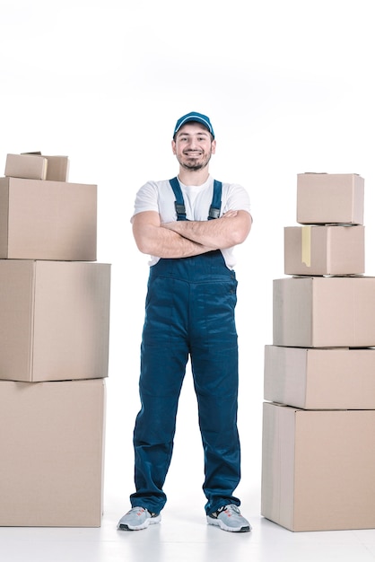 Confident deliveryman between packages