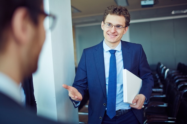 Confident entrepreneur holding laptop