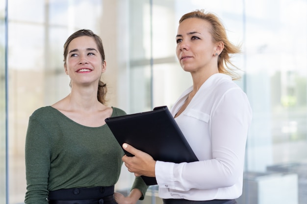 Free photo confident estate agents admiring neighbor building