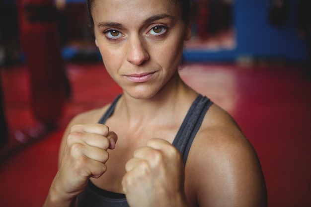 Confident female boxer performing boxing stance