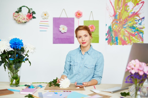 Confident floral designer at messy desk