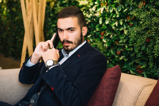 Confident handsome man talking on phone