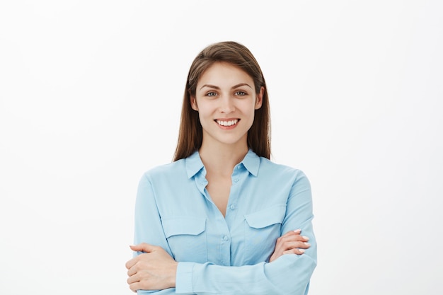 Confident happy brunette businesswoman posing in the studio