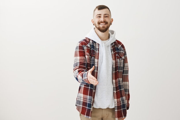 Confident happy hipster extend hand for handshake, greeting someone