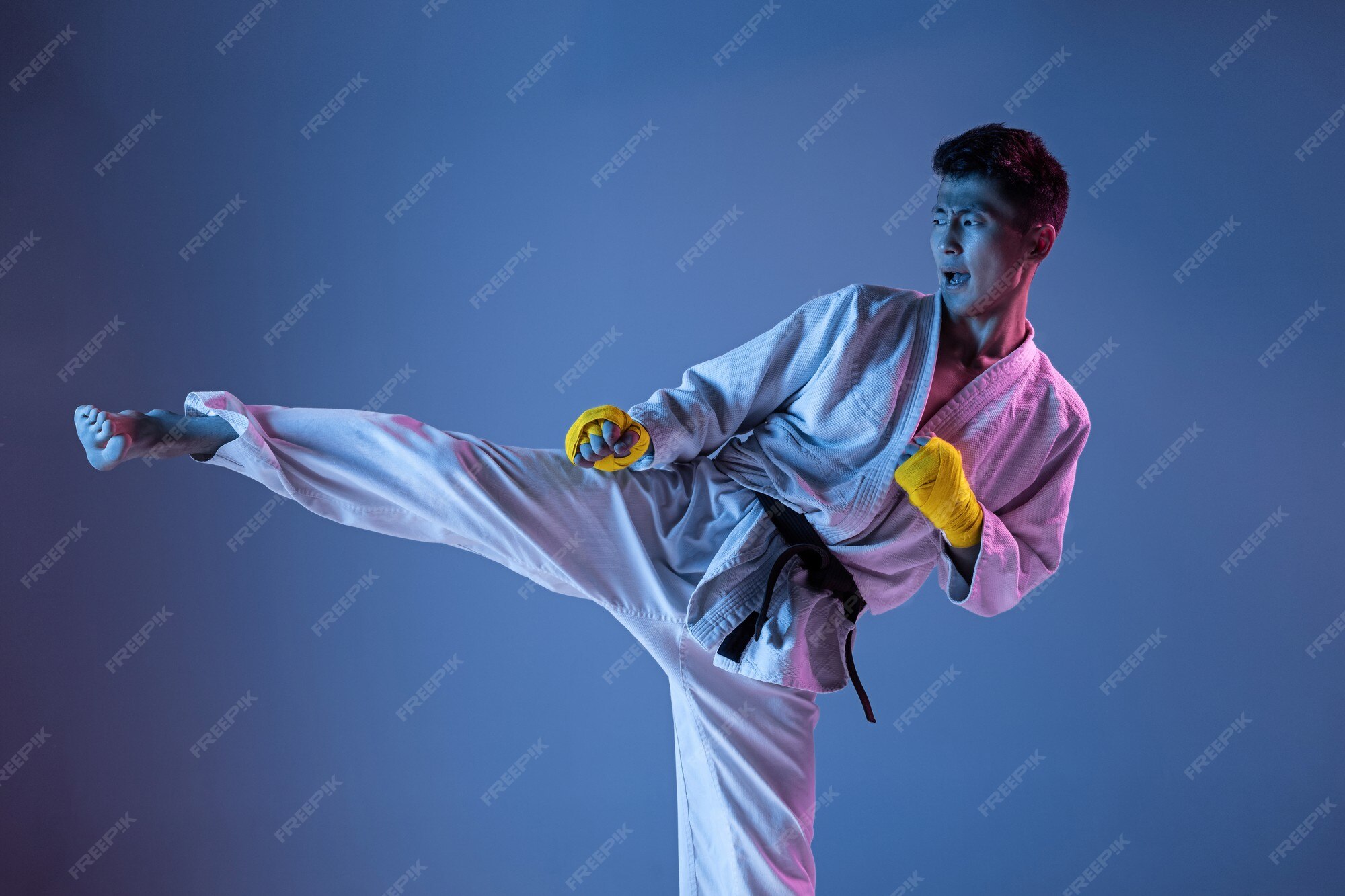 Free Photo | Confident korean man in kimono practicing hand-to-hand combat, martial  arts. young male fighter with black belt training on gradient background in  neon light. concept of healthy lifestyle, sport.