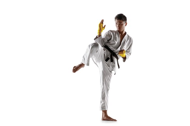 Confident korean man in kimono practicing hand-to-hand combat, martial arts