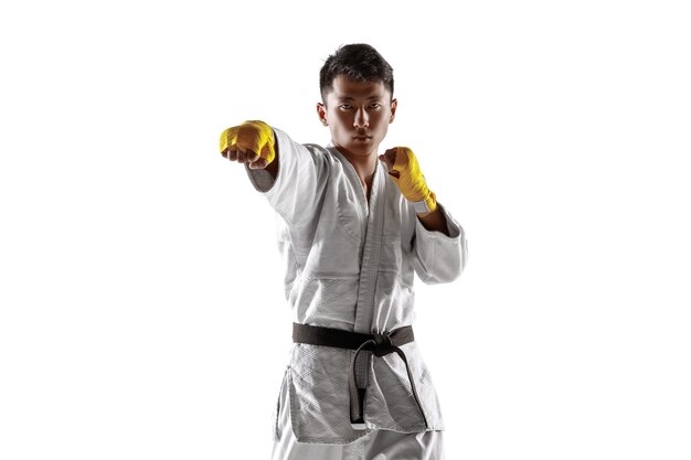 Confident korean man in kimono practicing hand-to-hand combat, martial arts