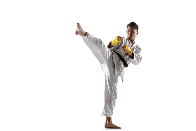 Confident korean man in kimono practicing handtohand combat martial arts