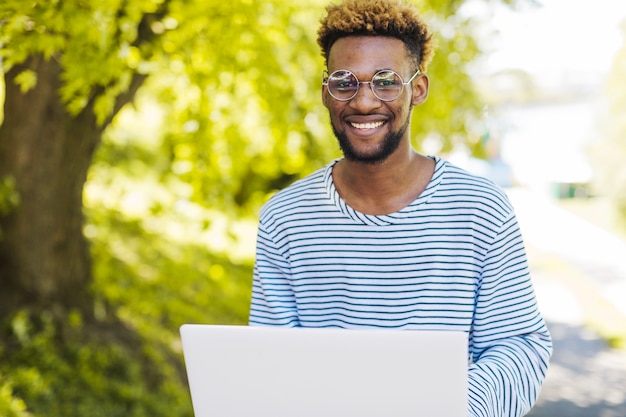 Confident man posing with laptop