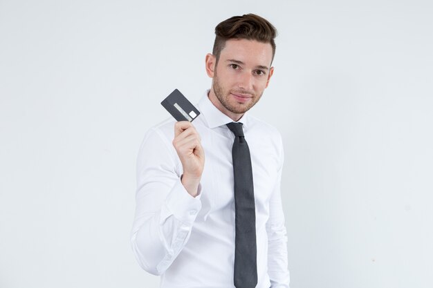 Confident man using credit card to be mobile