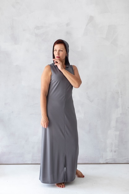 Confident mature woman in grey dress