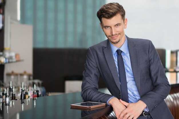 Confident Middle-aged Businessman at Cafe Counter