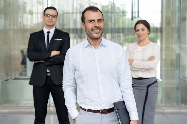 Confident optimistic businessman in light blue shirt and his tea