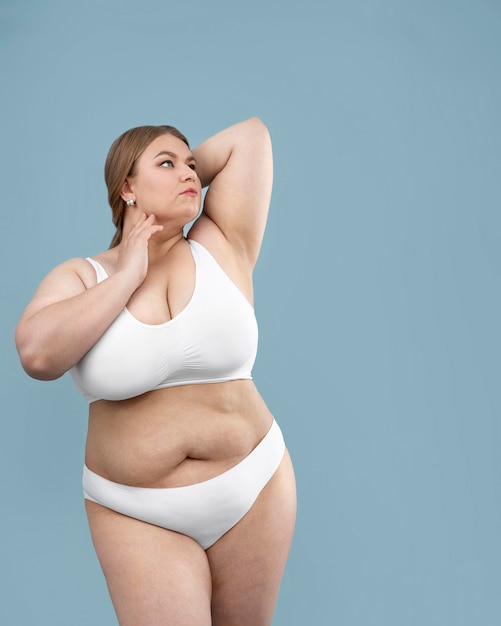 Confident oversized woman posing in lingerie