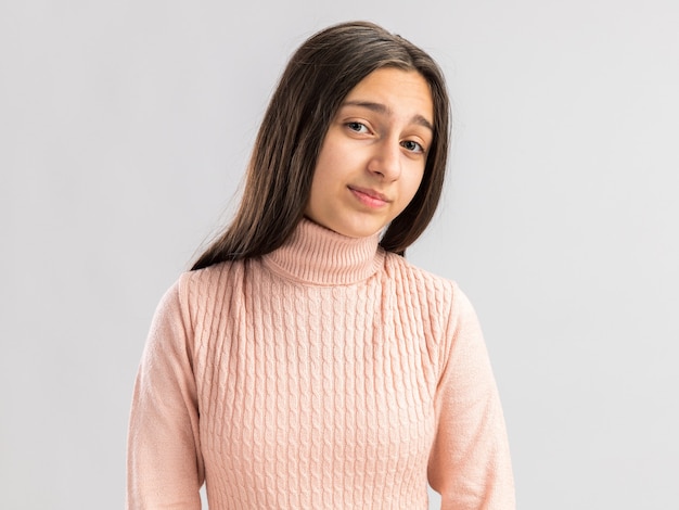 Confident pretty teenage girl looking at front isolated on white wall with copy space