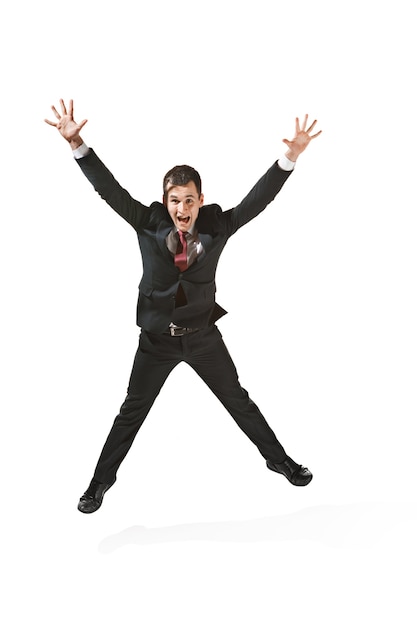 Free photo confident professional jumping in foreground of the camera. diplomat on white studio background. caucasian young man at studio