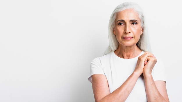 Confident senior woman holding hands