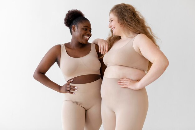 Confident smiley women posing while wearing a body shaper