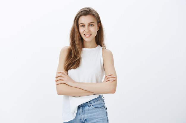 Confident smiling blond girl cross arms chest and looking sassy