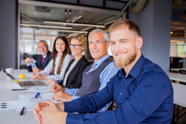 Confident smiling businesspeople sitting together in business meeting