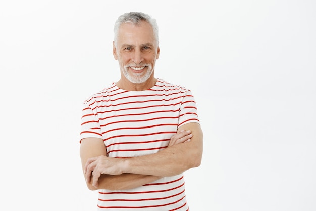 Confident smiling grandfather cross arms chest and looking happy