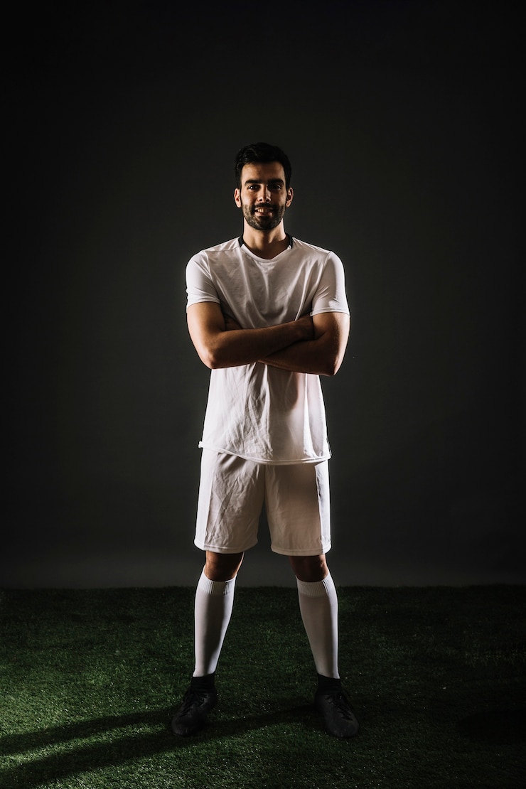 Free Photo confident soccer player looking at camera