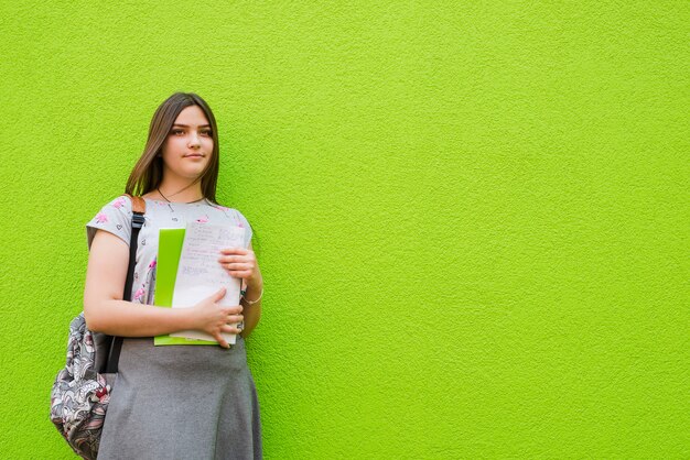 Confident student posing with notepad