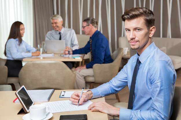 Confident Successful Young Man Working in Cafe