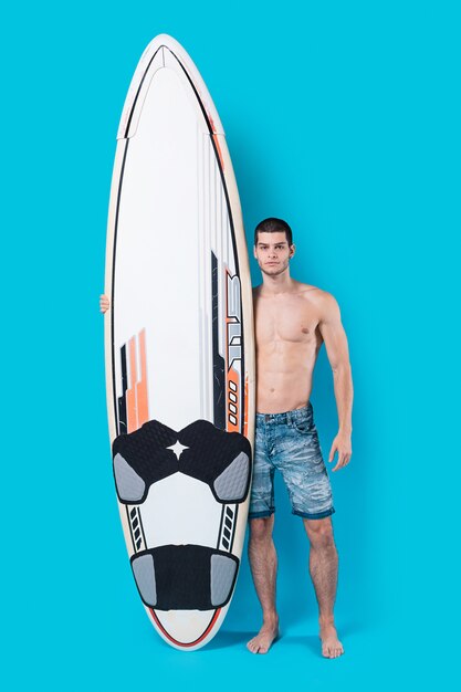 Confident surfer holding a surfboard