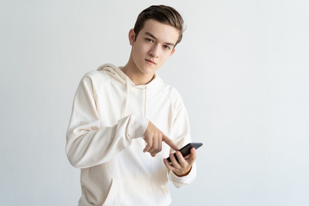 Confident teenage guy advertising new mobile app