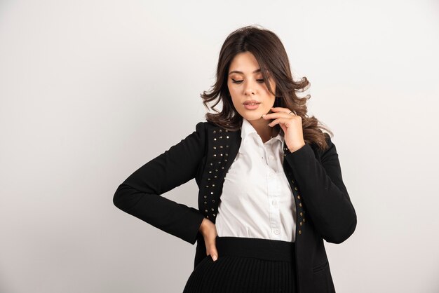 Confident woman in black jacket posing