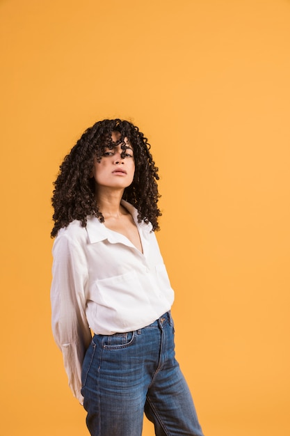 Confident woman holding arms back and looking at camera 