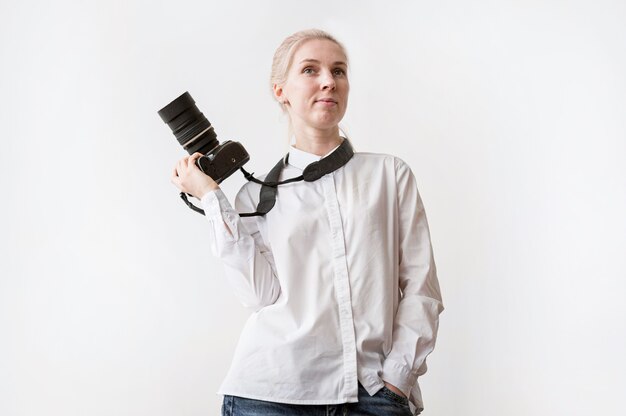 Confident woman holding a camera photo