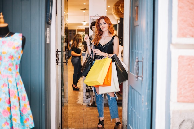 Confident woman posing in shop doorway