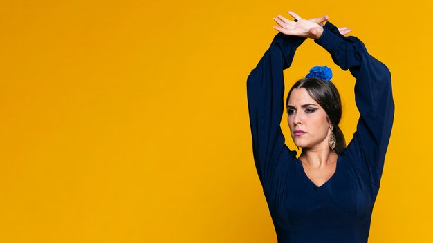 Confident woman raising hands with copy space