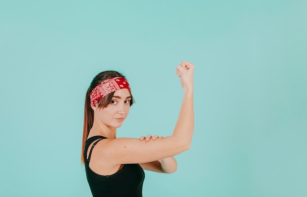 Confident woman showing biceps