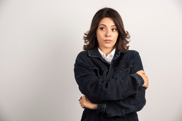 Confident woman standing on white.