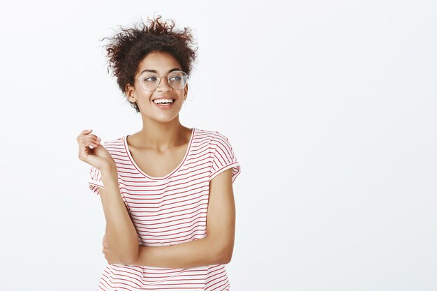 Confident woman with afro hairstyle posing in the studio