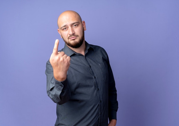 Confident young bald call center man showing one with hand isolated on purple  with copy space