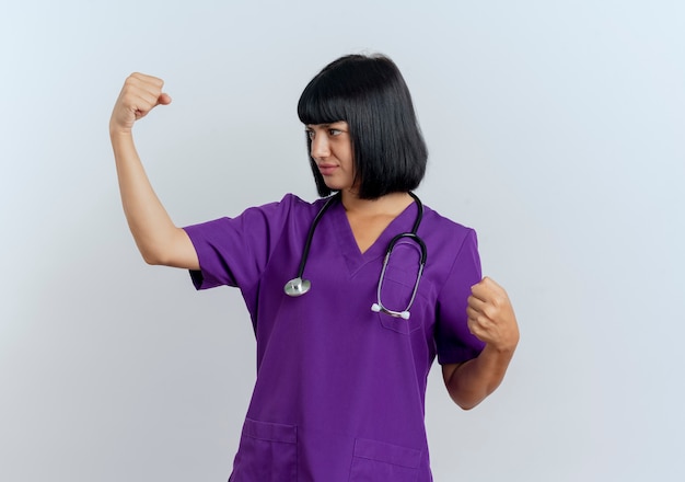 Confident young brunette female doctor in uniform with stethoscope