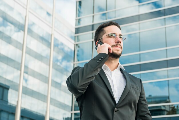 Confident young businessman holding document in hand