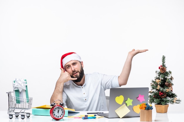 Confident young businessman with santa claus hat working at new year