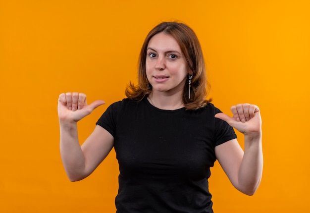 Confident young casual woman pointing at herself on isolated orange space