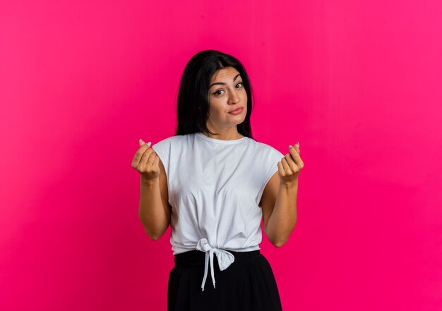 Confident young caucasian girl gestures money hand sign 