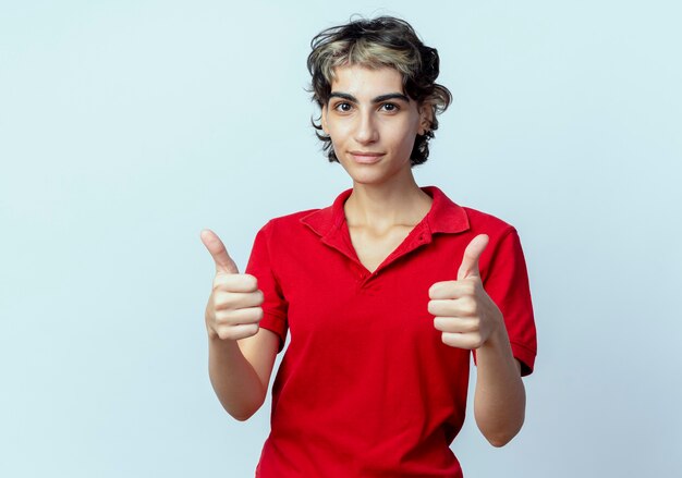 Confident young caucasian girl with pixie haircut showing thumbs up isolated on white background with copy space