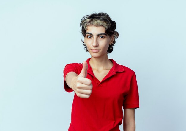Confident young caucasian girl with pixie haircut stretching out hand at camera showing thumb up isolated on white background with copy space