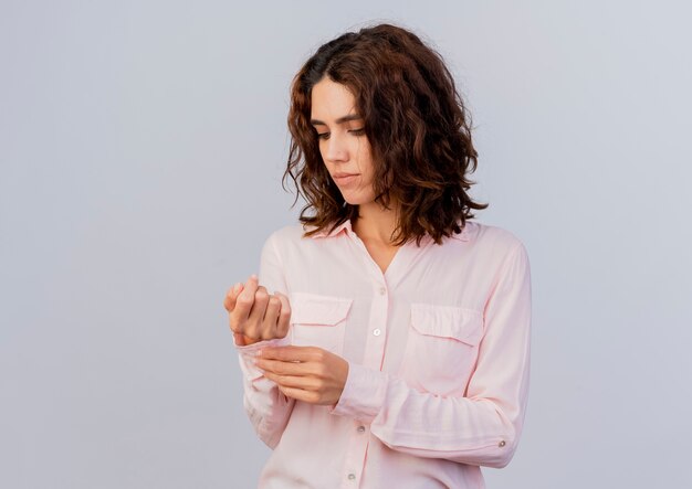 Confident young caucasian woman buttons up sleeve